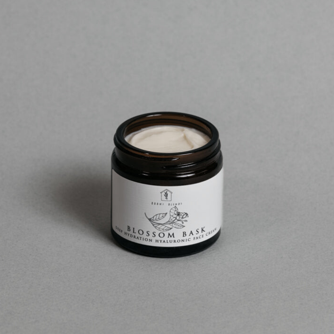 A photo of an open, amber jar of our deeply hydrating hyaluronic Blossom Bask face cream